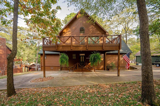 view of front of house featuring a wooden deck and a patio area