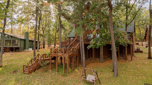 view of play area featuring a lawn and a deck