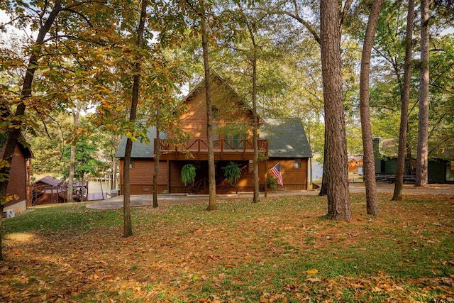 back of property featuring a wooden deck, a patio, and a yard