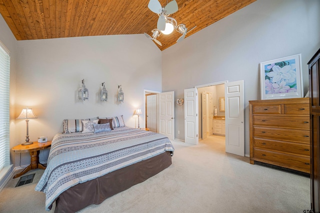 carpeted bedroom with high vaulted ceiling, wooden ceiling, ceiling fan, and ensuite bath