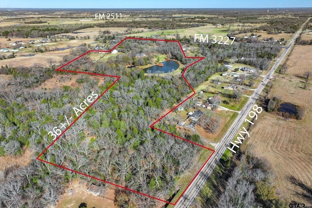 aerial view featuring a rural view and a water view