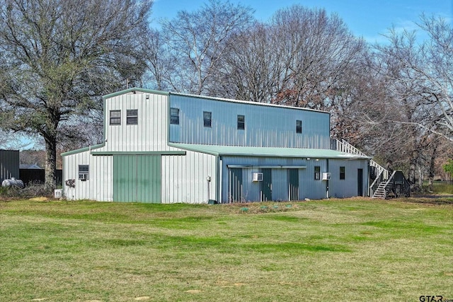 rear view of house with a yard and an outbuilding