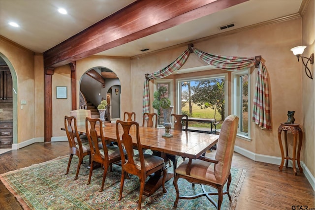 dining room with crown molding and wood-type flooring