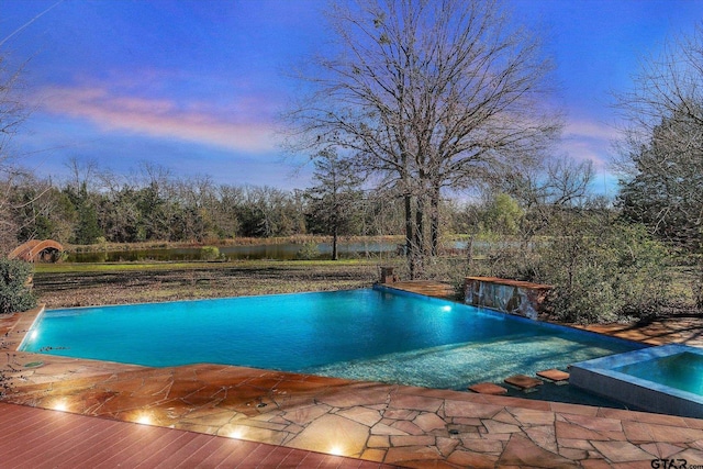 view of pool at dusk