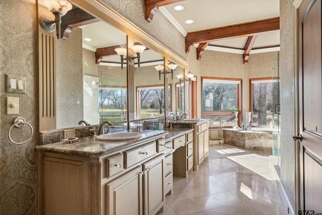 bathroom featuring tiled bath, vanity, beamed ceiling, and ornamental molding