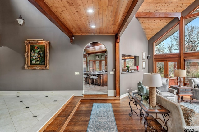 corridor with wooden ceiling, a towering ceiling, and french doors