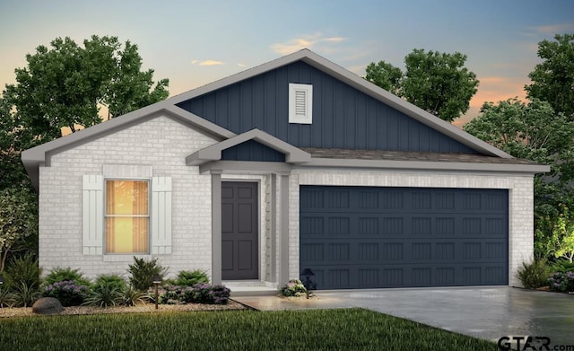 205 Highland Forest Dr, Gilmer, TX 75644 - view of front facade with brick siding, board and batten siding, concrete driveway, and a garage