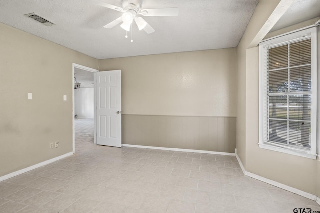 spare room featuring ceiling fan and a textured ceiling