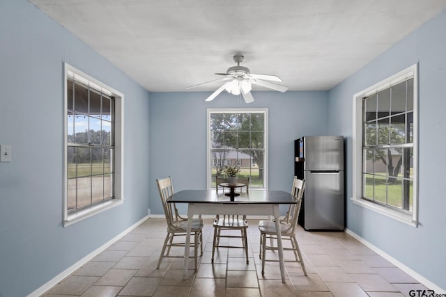 dining space featuring ceiling fan, light tile patterned flooring, and plenty of natural light