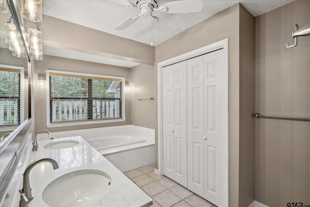 381 Winding Trl, Holly Lake Ranch, TX 75765 - bathroom with a closet, double vanity, a bath, tile patterned floors, and a ceiling fan