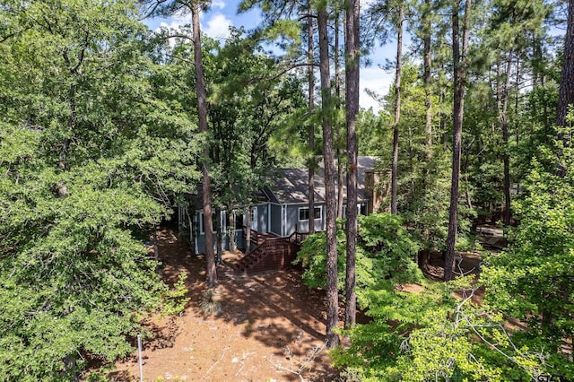 381 Winding Trl, Holly Lake Ranch, TX 75765 - view of front facade with stairs and a wooden deck