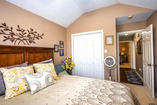 bedroom featuring vaulted ceiling, carpet floors, and a closet