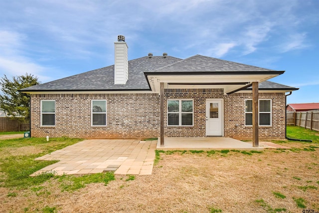 rear view of house featuring a yard and a patio area