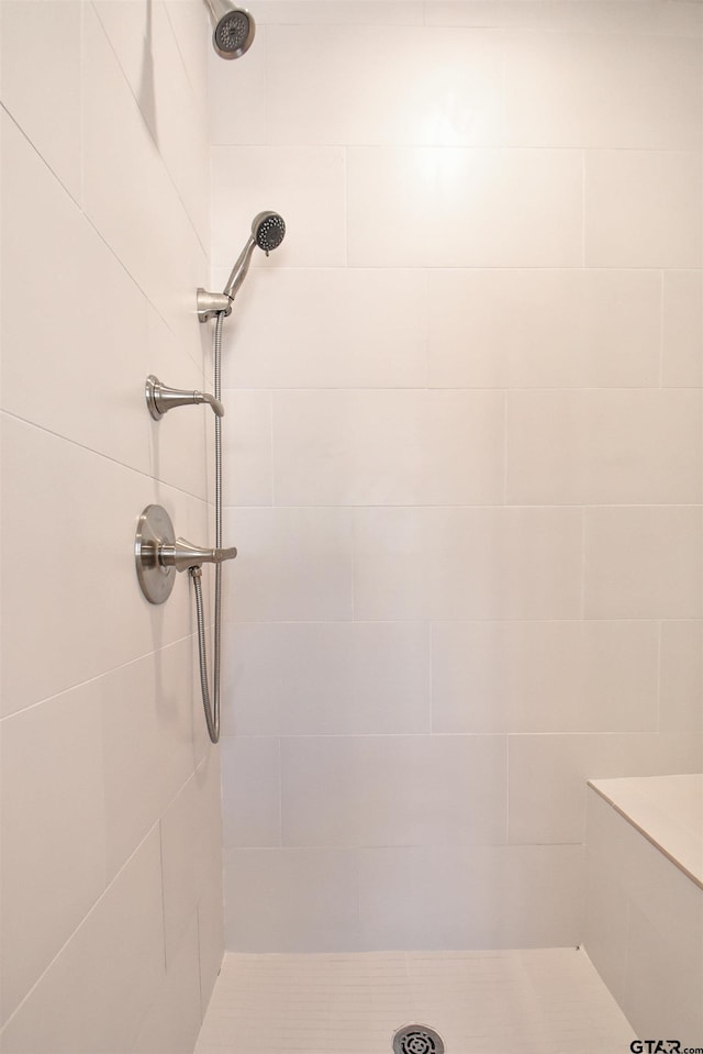 bathroom with tiled shower