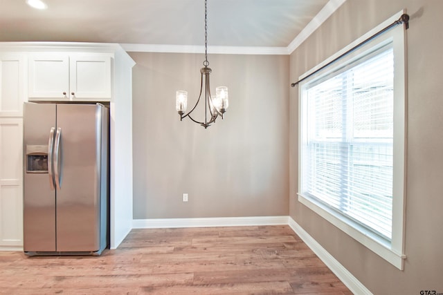 kitchen with decorative light fixtures, white cabinets, crown molding, light hardwood / wood-style floors, and stainless steel refrigerator with ice dispenser