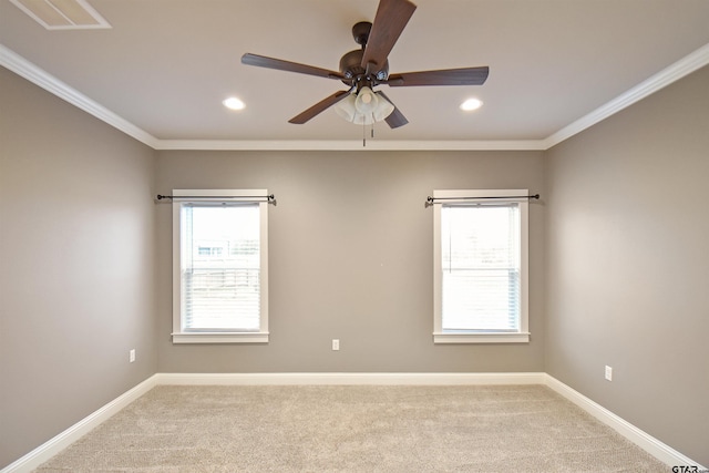 carpeted empty room featuring ornamental molding, plenty of natural light, and ceiling fan