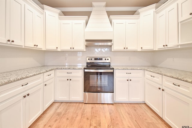 kitchen featuring white cabinetry, light stone counters, and stainless steel electric range