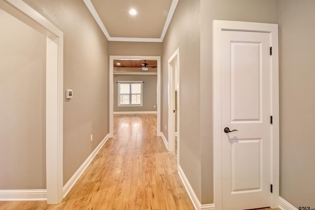 hallway featuring crown molding and light wood-type flooring