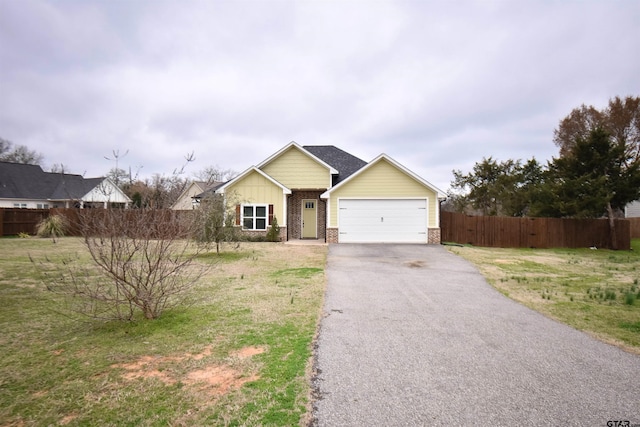 view of front of house featuring a garage and a front lawn