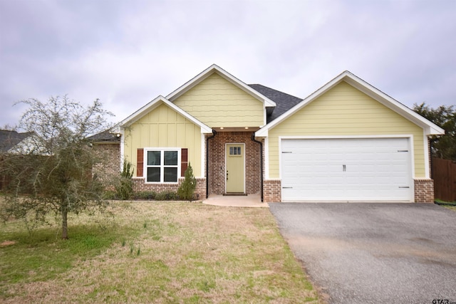 craftsman-style home featuring a garage and a front yard