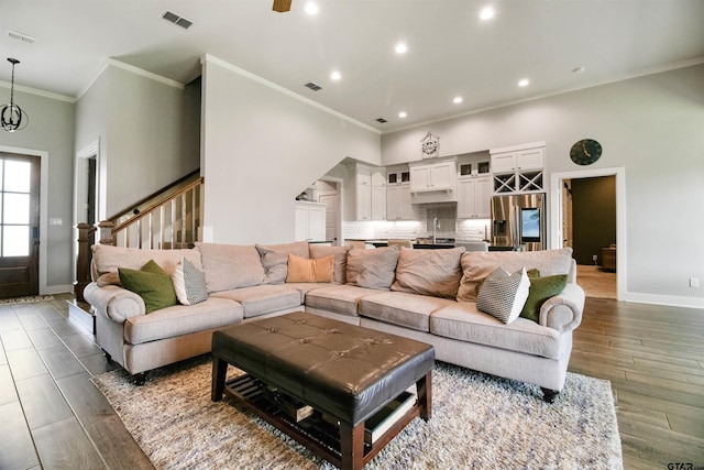 2946 Guinn Farms Rd, Tyler, TX 75707 - living room with crown molding, stairs, dark wood finished floors, and recessed lighting