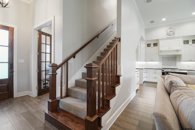 2946 Guinn Farms Rd, Tyler, TX 75707 - foyer entrance featuring healthy amount of natural light, stairs, crown molding, dark wood-type flooring, and a high ceiling