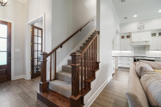2946 Guinn Farms Rd, Tyler, TX 75707 - foyer entrance featuring healthy amount of natural light, stairs, crown molding, dark wood-type flooring, and a high ceiling