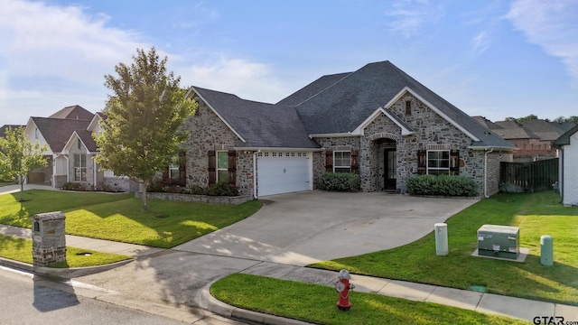 2946 Guinn Farms Rd, Tyler, TX 75707 - view of front facade with stone siding, driveway, a garage, and a shingled roof