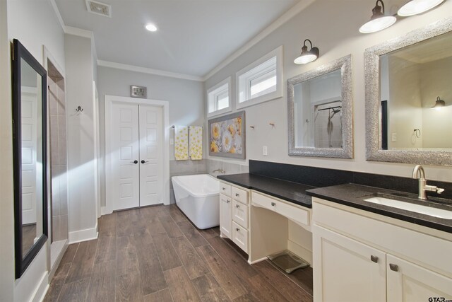 2946 Guinn Farms Rd, Tyler, TX 75707 - bathroom with crown molding, vanity, a soaking tub, wood finished floors, and recessed lighting