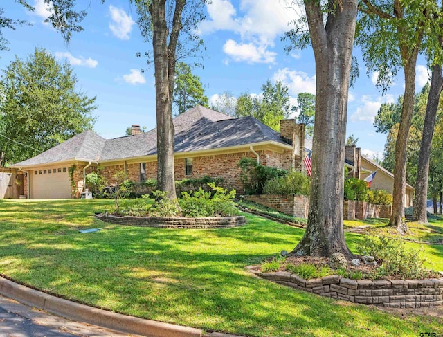 single story home featuring a garage and a front lawn