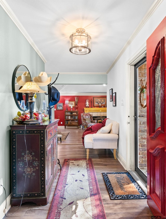 corridor with an inviting chandelier, hardwood / wood-style flooring, and crown molding