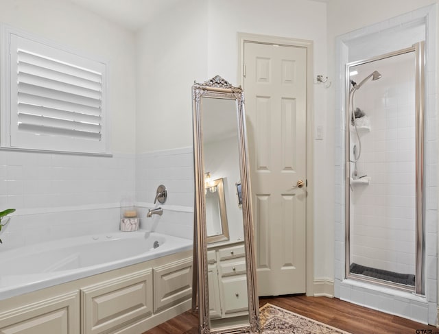 bathroom with hardwood / wood-style flooring and plus walk in shower