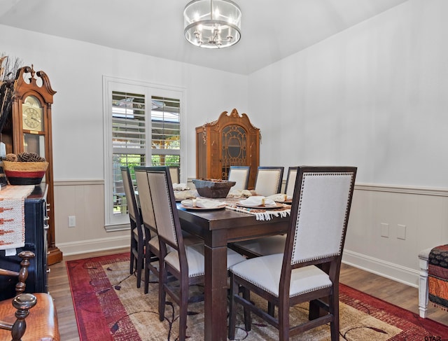 dining area featuring an inviting chandelier and dark hardwood / wood-style flooring