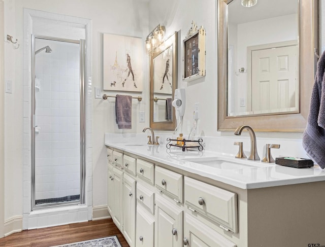 bathroom with an enclosed shower, vanity, and hardwood / wood-style floors