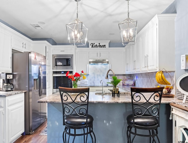 kitchen featuring dark hardwood / wood-style flooring, white cabinetry, and appliances with stainless steel finishes