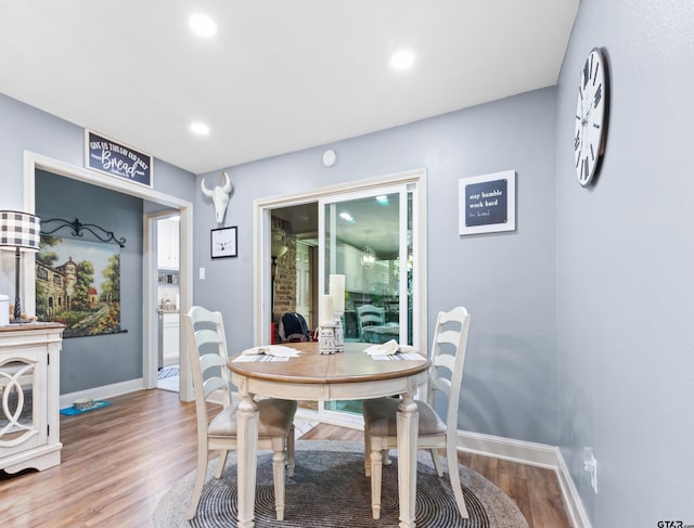 dining space with hardwood / wood-style flooring