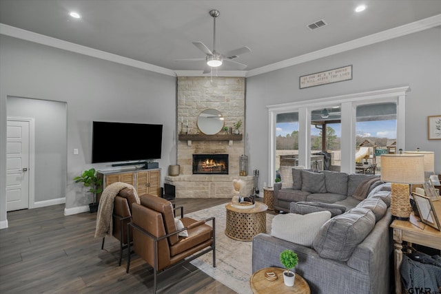 living area with visible vents, crown molding, baseboards, and dark wood-style flooring