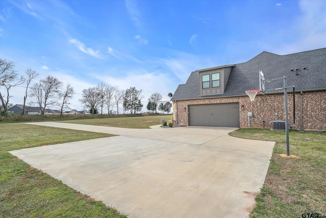 exterior space featuring brick siding, concrete driveway, a yard, and a shingled roof