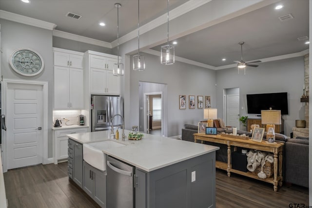 kitchen with visible vents, gray cabinets, a sink, open floor plan, and stainless steel appliances