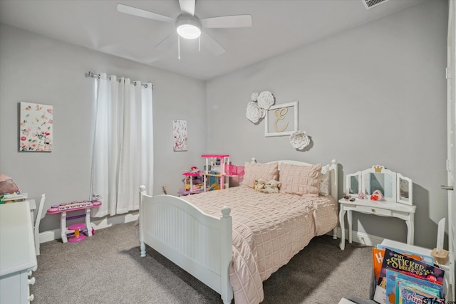 carpeted bedroom with visible vents, a ceiling fan, and baseboards