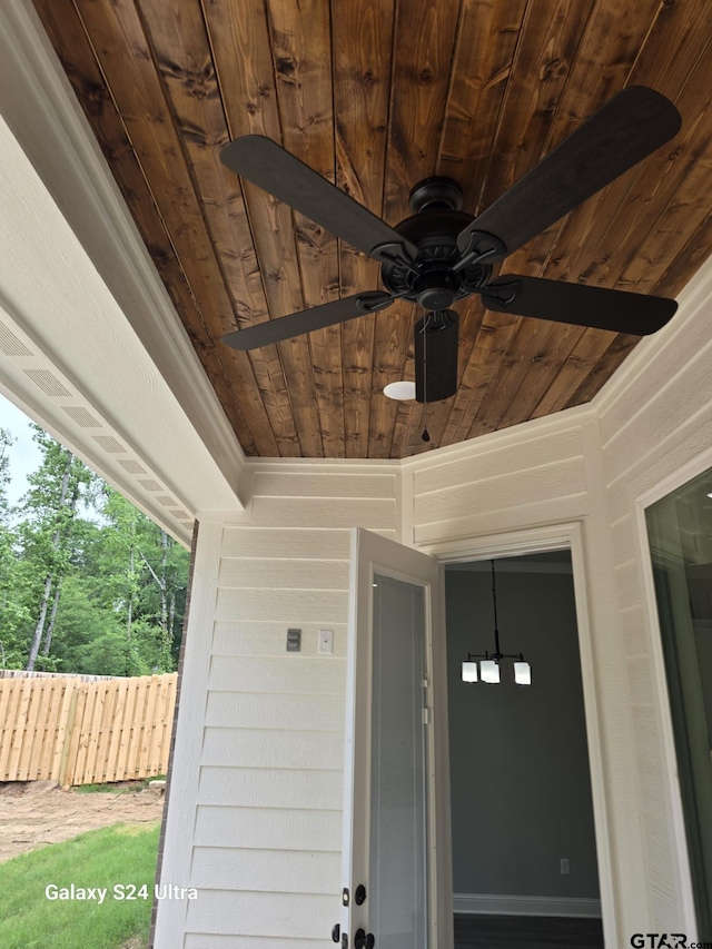 exterior details with fence and a ceiling fan