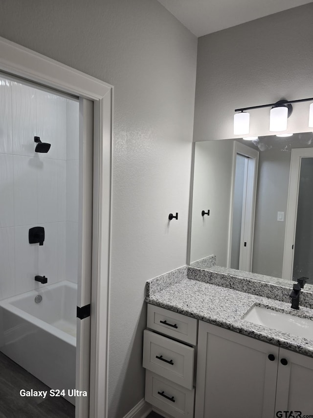 bathroom with vanity,  shower combination, and wood finished floors