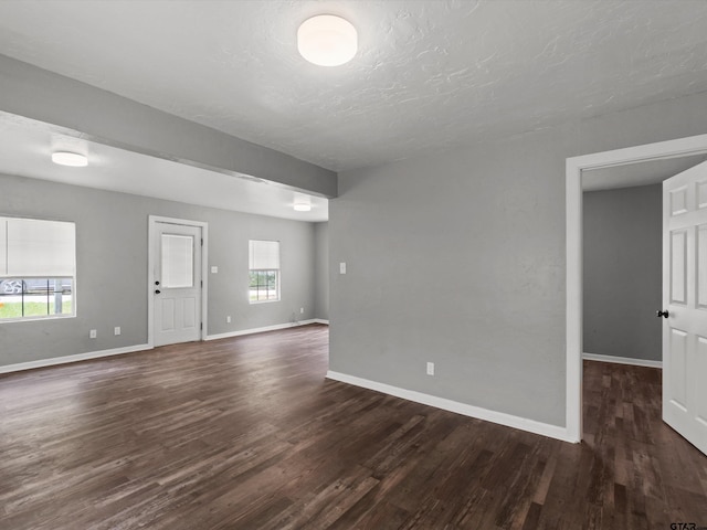 509 Clark St, Gilmer, TX 75644 - spare room featuring dark wood finished floors and a textured ceiling