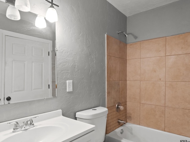 509 Clark St, Gilmer, TX 75644 - full bathroom with a textured wall, vanity, and tub / shower combination