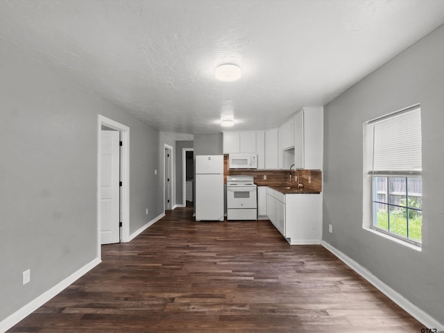 509 Clark St, Gilmer, TX 75644 - kitchen featuring white appliances, white cabinetry, dark wood finished floors, and dark countertops