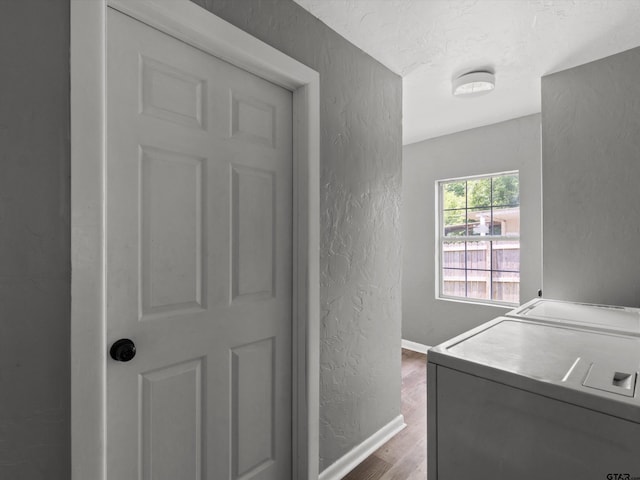 509 Clark St, Gilmer, TX 75644 - laundry area with a textured wall, washer / clothes dryer, wood finished floors, and a textured ceiling