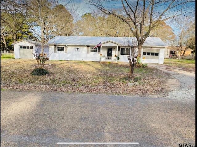 ranch-style home with a garage and covered porch