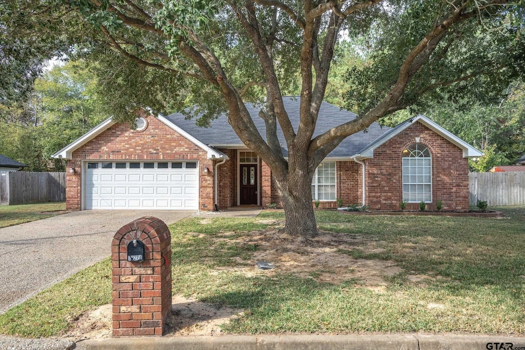 ranch-style house featuring a garage and a front lawn