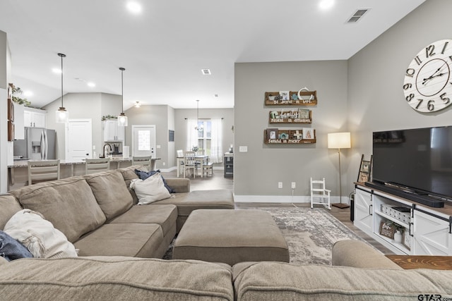 living room with baseboards, visible vents, recessed lighting, and wood finished floors