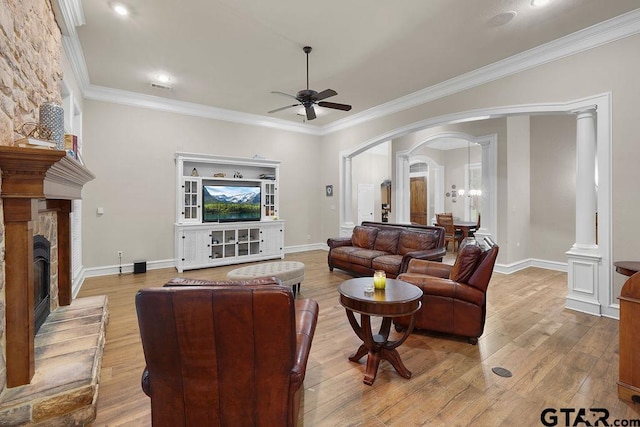 2322 Kingsmill Cir, Tyler, TX 75703 - living area with arched walkways, a ceiling fan, a stone fireplace, wood finished floors, and ornamental molding